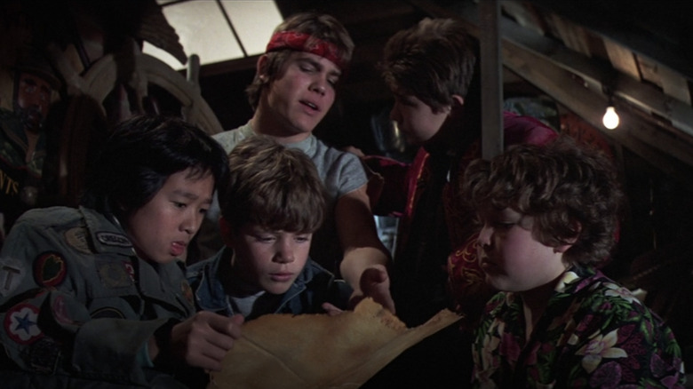 The Goonies looking at a treasure map