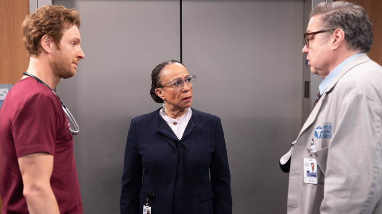 Will Halstead, Sharon Goodwin, and Daniel Charles in front of an elevator