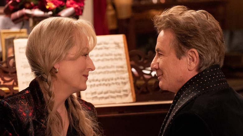 Loretta and Oliver sit at a piano