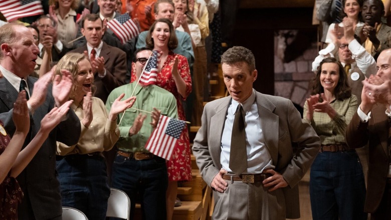 Oppenheimer standing next to a 50-state flag