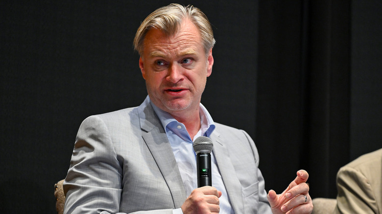 Christopher Nolan speaking into microphone