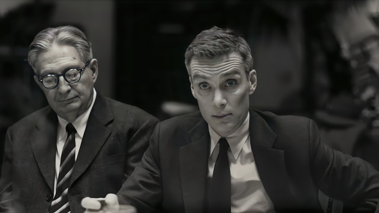 J. Robert Oppenheimer in a suit sitting down