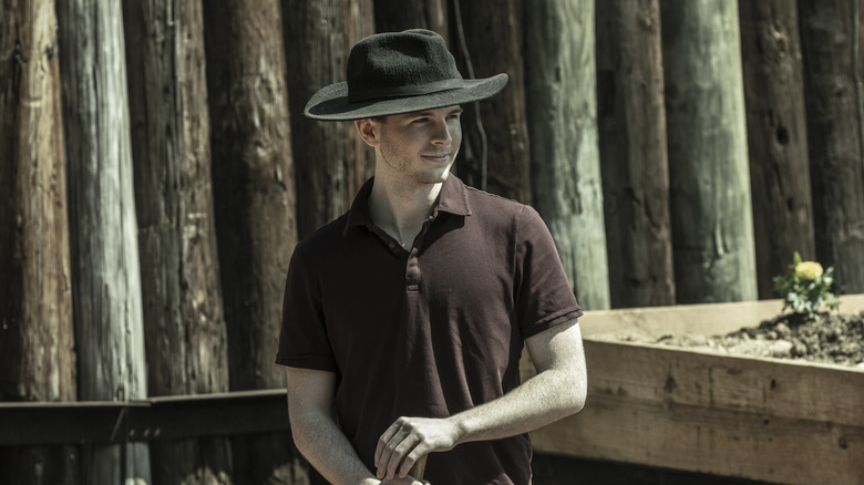 Chandler Riggs smiling and wearing a farm hat