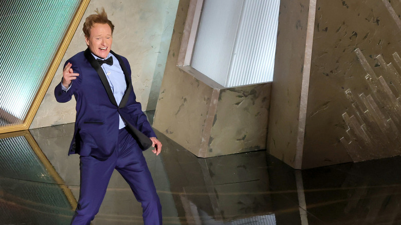 Conan O'Brien gesturing wildly dring the Academy Awards