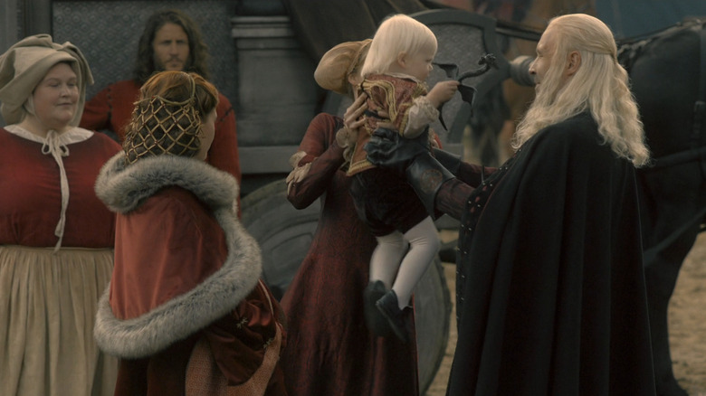 King Viserys holds his baby Aegon