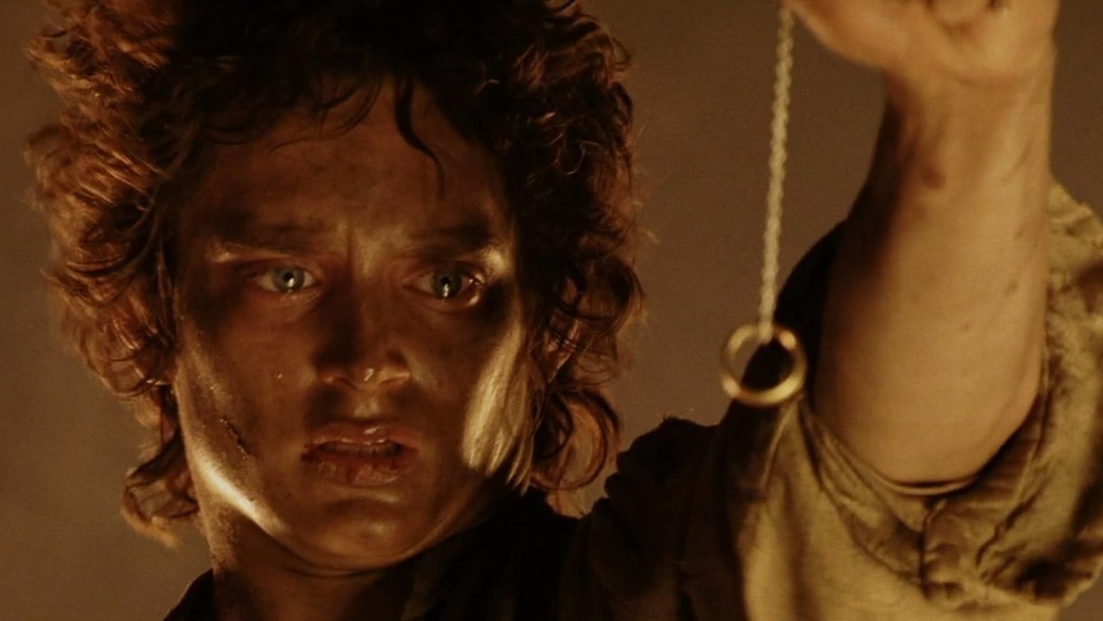 Frodo holding the One Ring