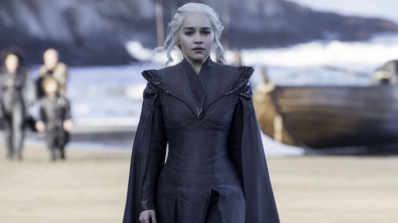 Emilia Clarke marching as Daenerys in black robe 