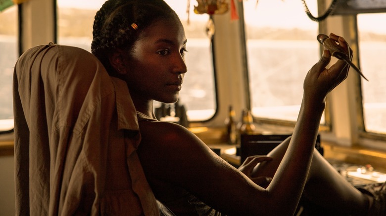 Cleo Holding Knife in Cockpit