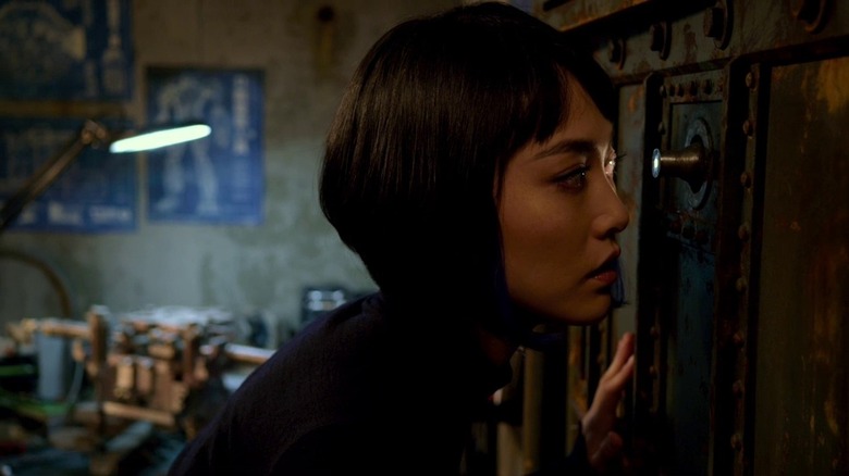 Rinko Kikuchi peering through a peephole