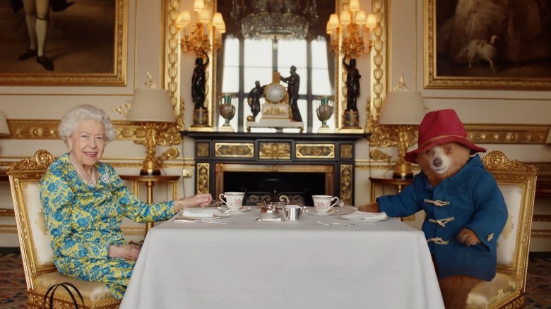 Queen Elizabeth II and Paddington Bear having tea