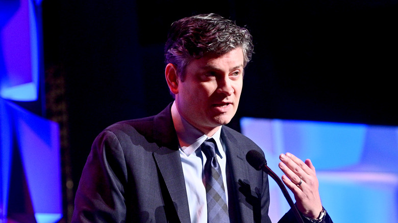 Mike Schur speaking into a microphone