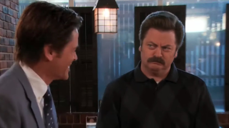 Ron staring at a smiling Chris