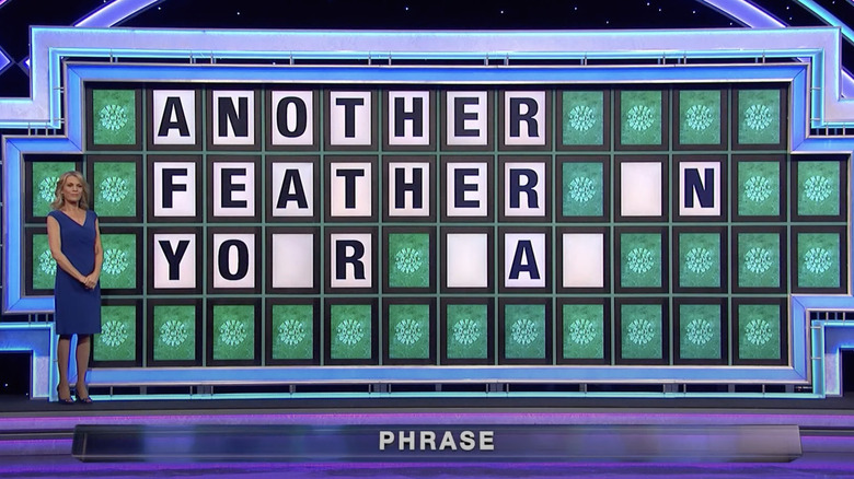 Vanna White listening for a contestant's guess on "Wheel of Fortune"