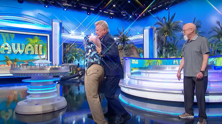 Pat Sajak puts Fred in headlock