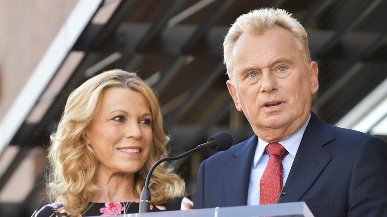 Vanna White and Pat Sajak at a podium