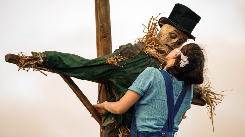 Pearl climbs onto scarecrow