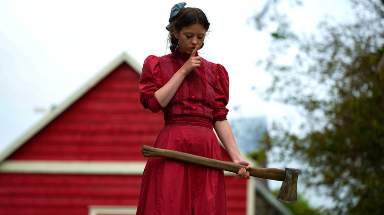 Pearl in red dress with axe