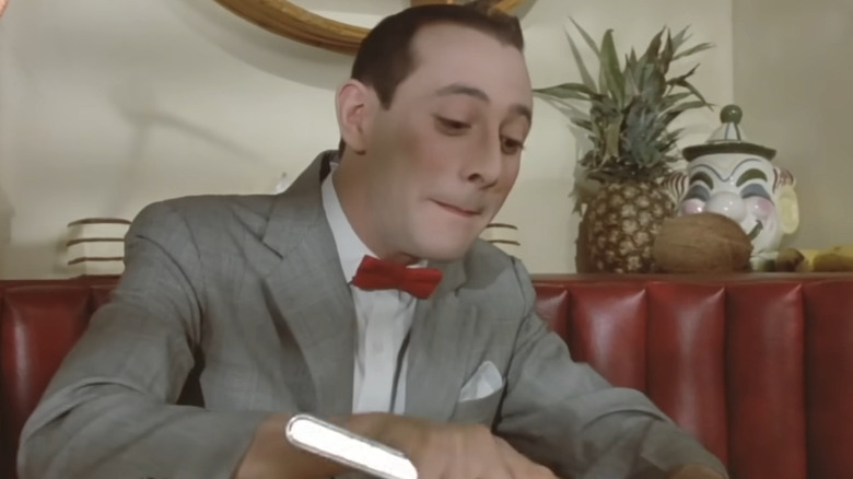 Pee-wee Herman cutting with knife