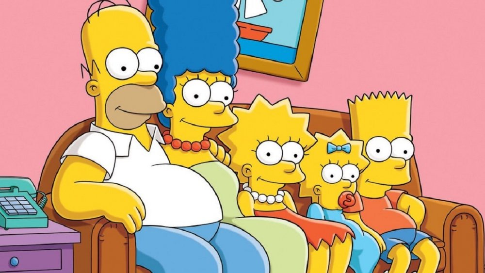 A publicity still of The Simpsons on their couch in a classic opening