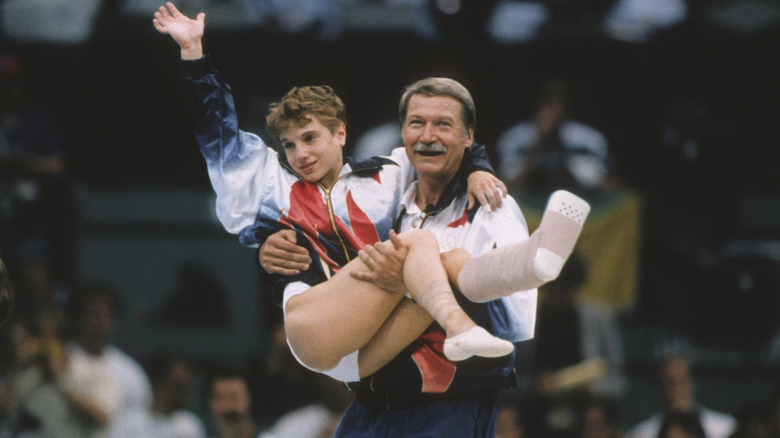 Kerri Strug is carried by Béla Károlyi