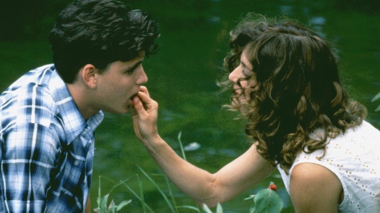 Vera feeding Eric a strawberry