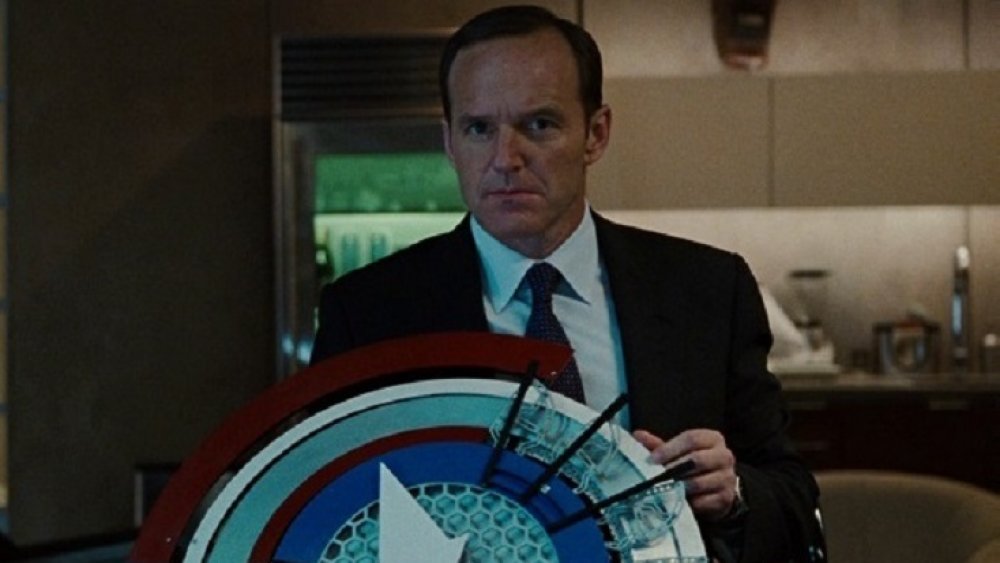 Agent Phil Coulson carrying a prototype of Captain America's shield