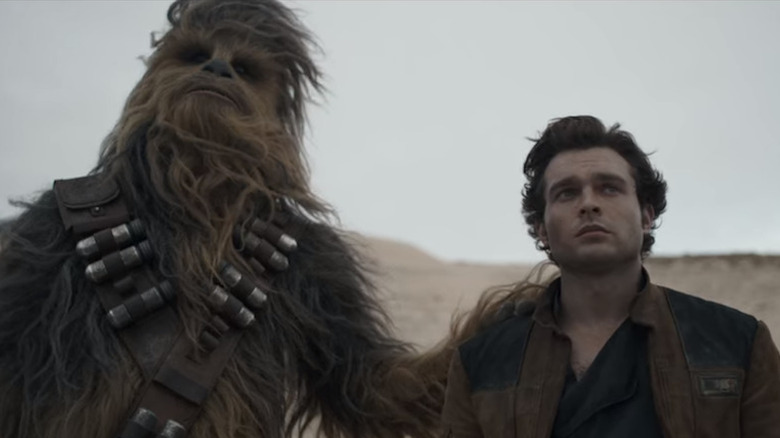 Chewbacca with hi hand on Han Solo's shoulder