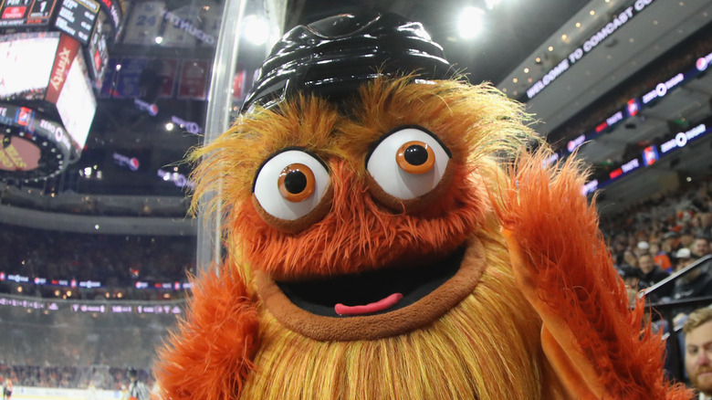 Gritty wearing a black hockey helmet