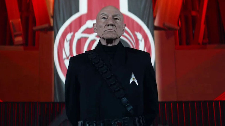 Picard in front of a red-and-black flag