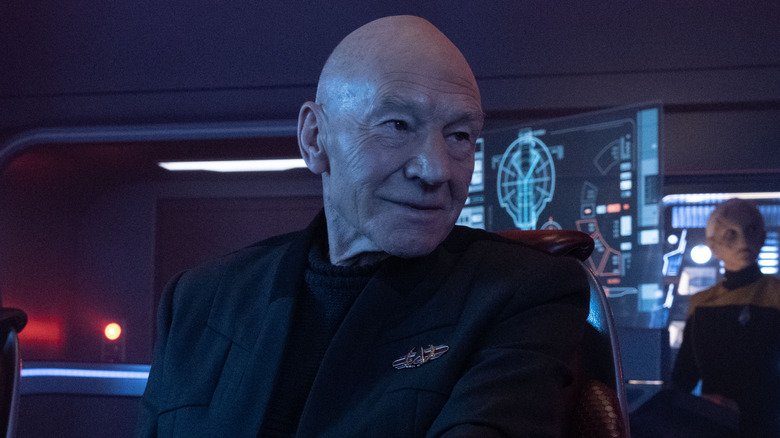 Jean-Luc Picard wearing black uniform on bridge