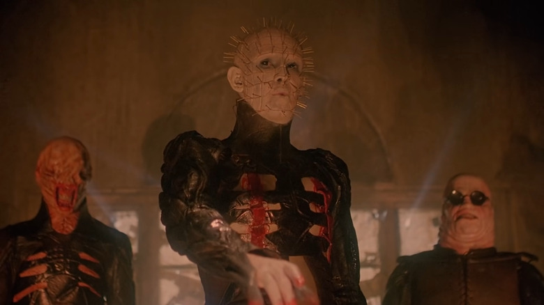 Pinhead talking with Cenobites behind him