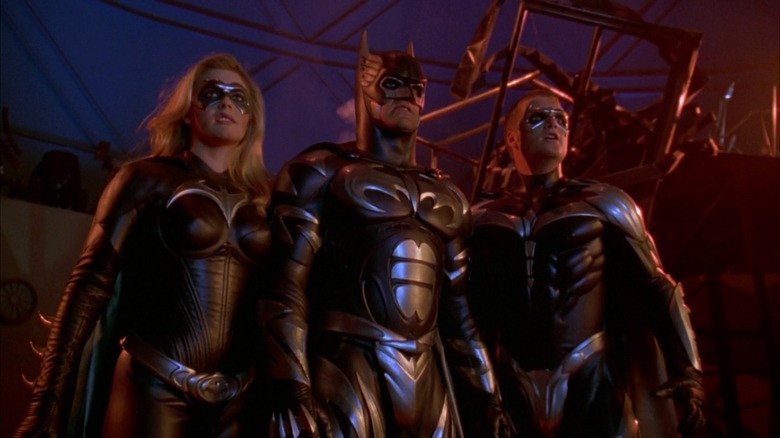 Batman, Batgirl, and Robin standing