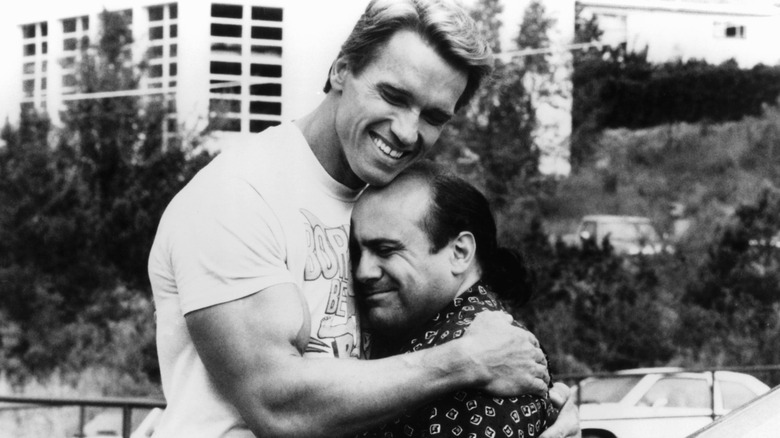 Danny DeVito and Arnold Schwarzenegger hugging