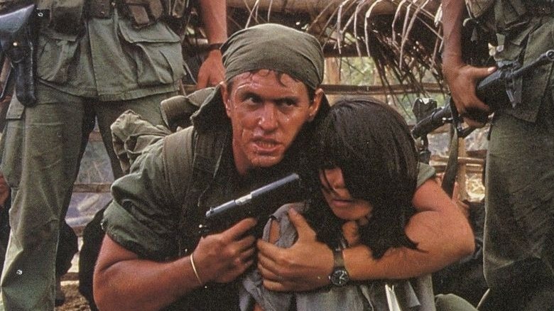 Sgt. Barnes holding a gun to a child's head