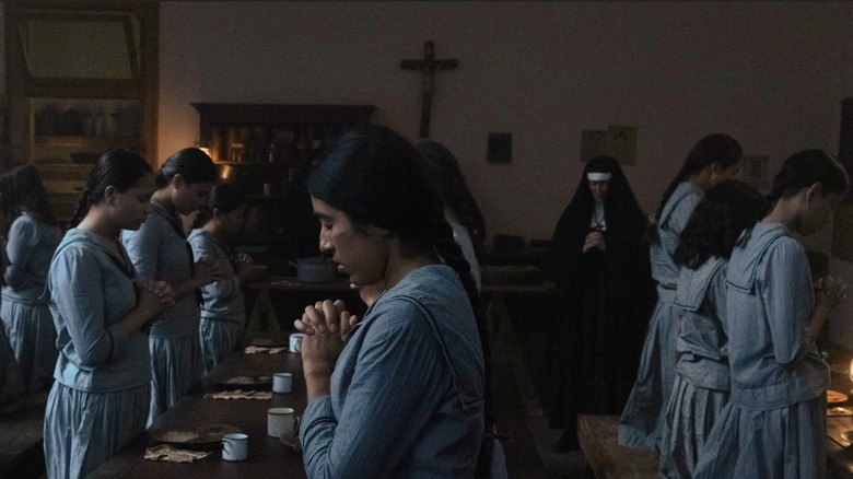 Indigenous women praying at Catholic boarding school