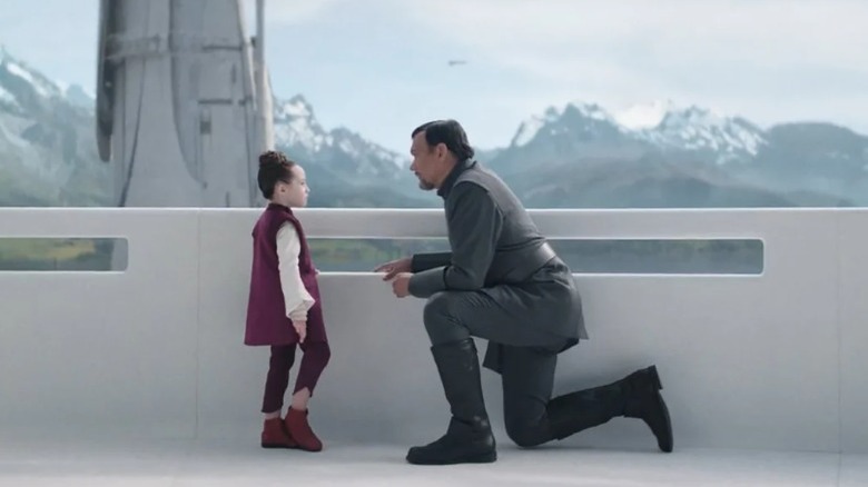 Bail Organa kneeling by Leia