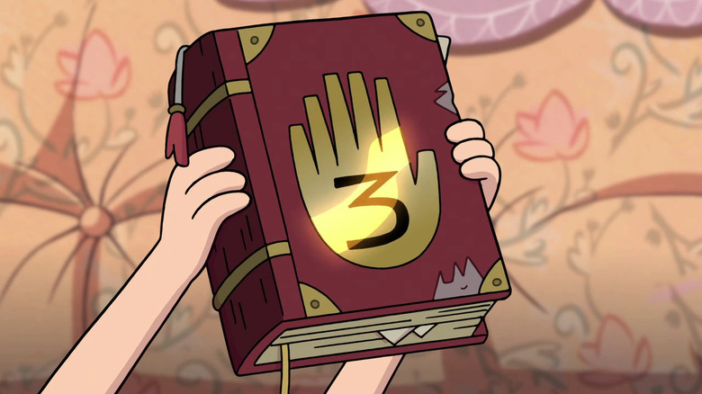 Dipper holding up journal