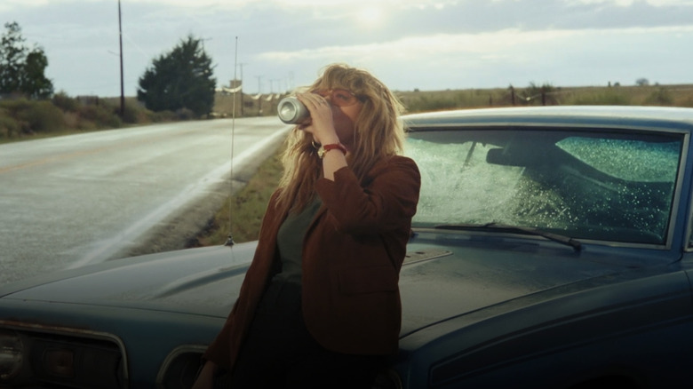 Charlie drinking beer by roadside