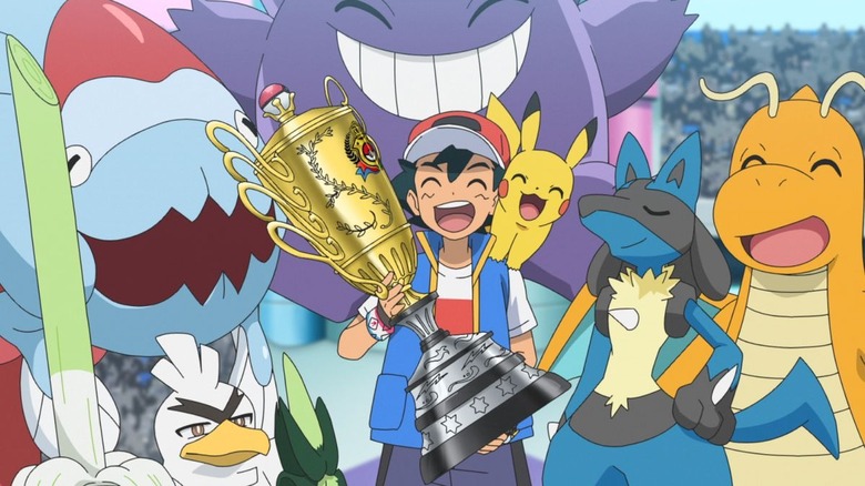 Ash holds his championship trophy surrounded by Pokémon