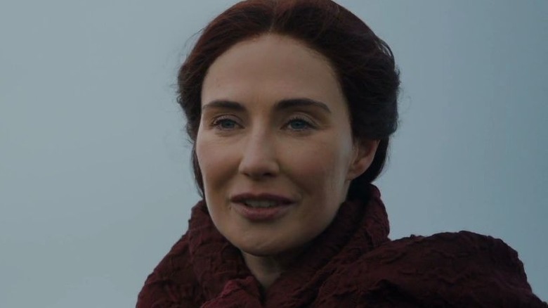 Melisandre smiling wearing red cloak