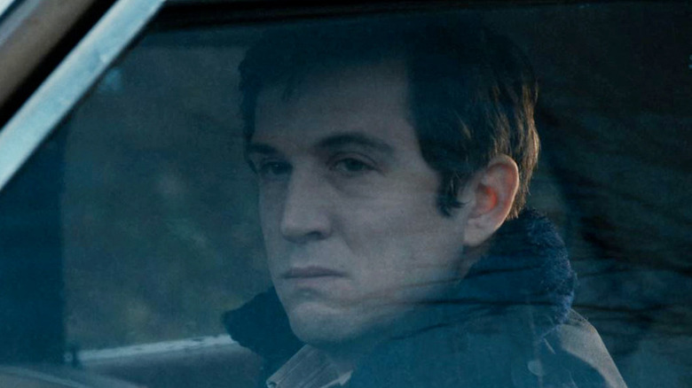 Guillaume Canet looks through a car window