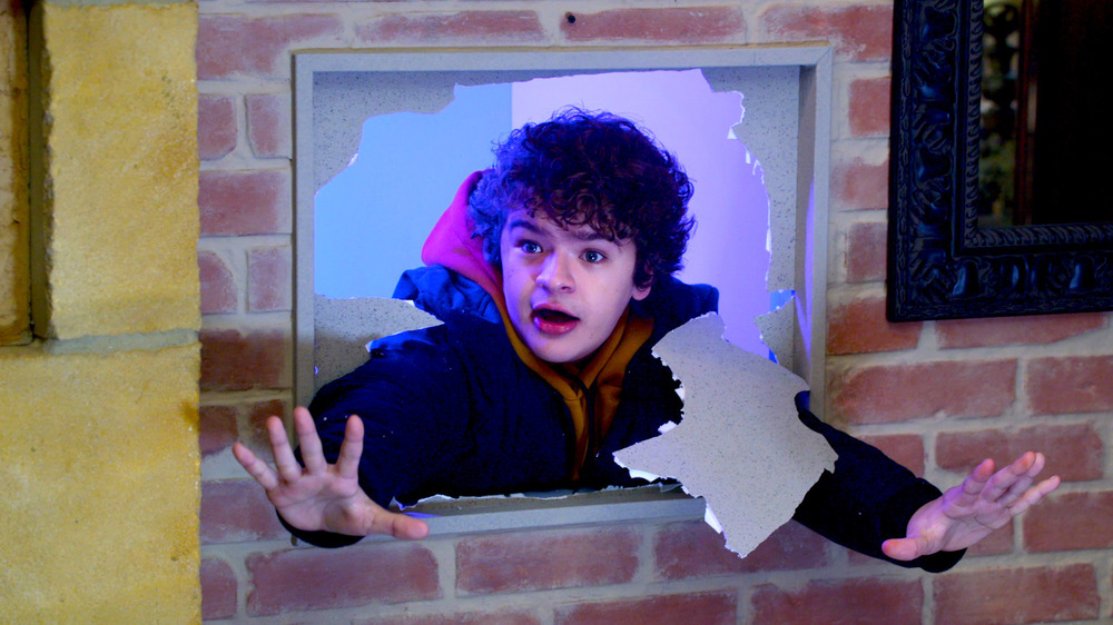 Gaten Matarazzo breaking through wallpaper