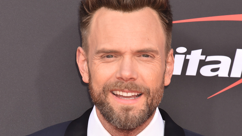 Joel McHale smiles at camera