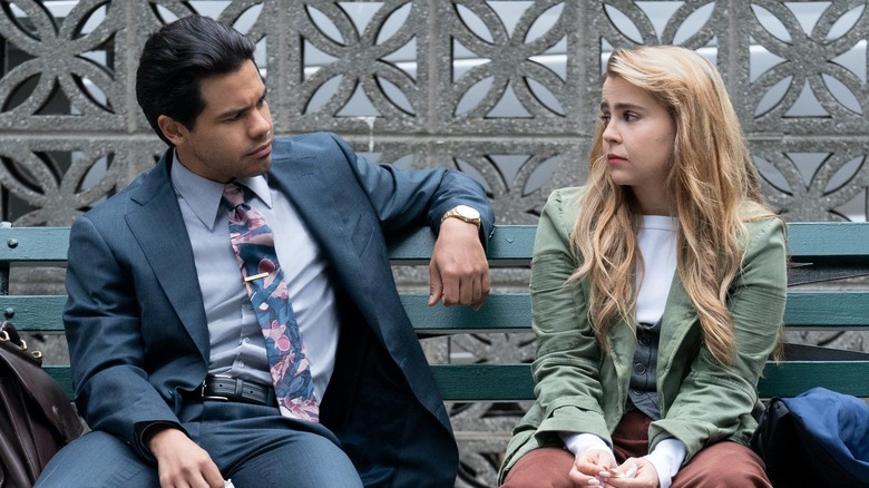 Mae Whitman and Carlos Valdes look at each other on bench