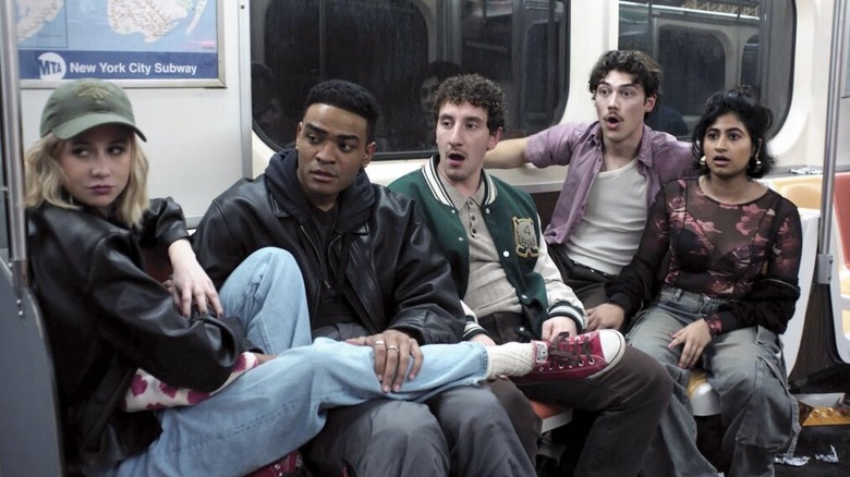 Five men and women sit on a subway car in "Adults" (2025)