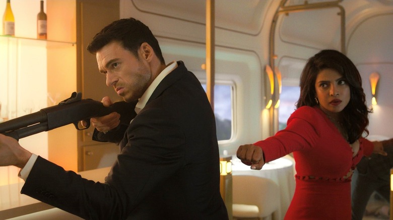 Mason holding gun and Nadia with fists extended in "Citadel"