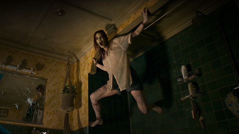 Possessed Ellie crawling on shower wall