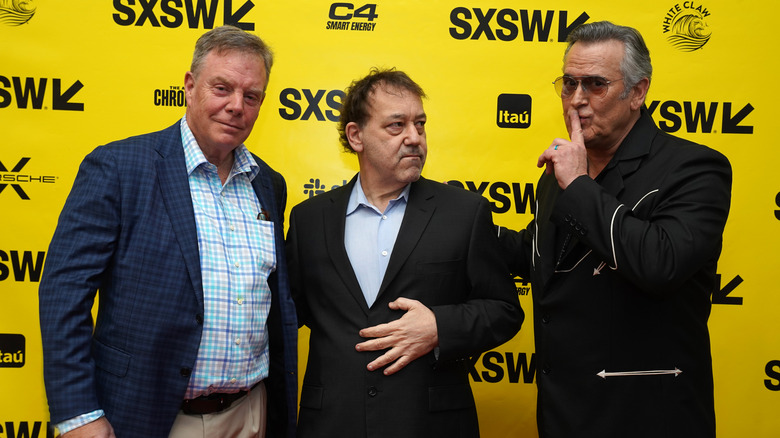 Rob Tapert, Sam Raimi, and Bruce Campbell posing at premiere