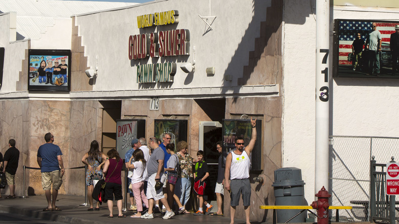 Tourists lining up outside shop