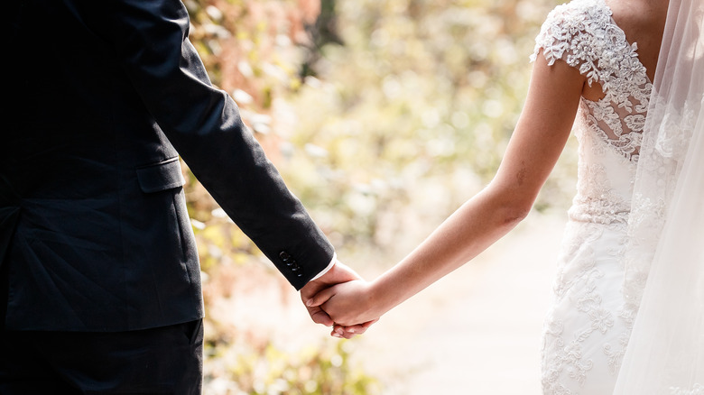 Bride and groom holding hands